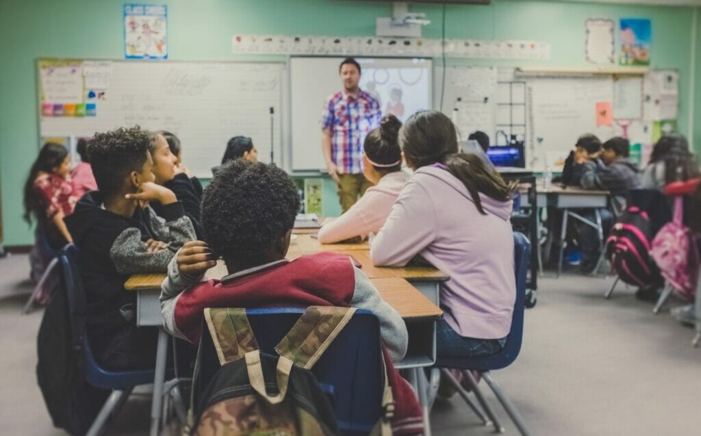 A teacher imparting valuable moral lessons to a group of attentive adult students, fostering a learning environment that encourages personal growth and development.