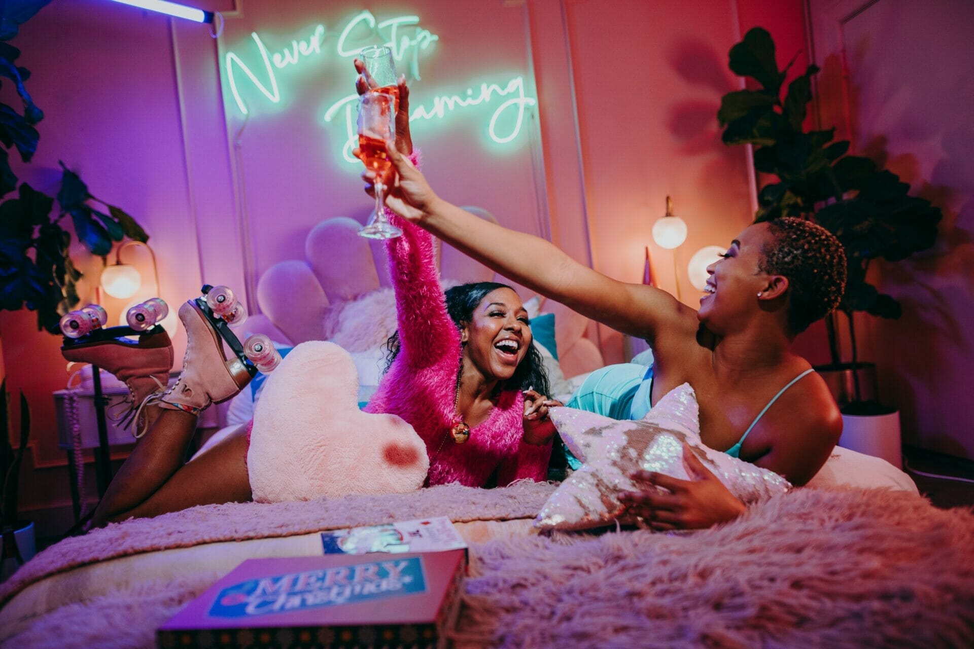 Two sisters, celebrating at an exciting bachelorette party with a red color scheme, joyfully indulging in glasses of wine. Perfect bachelorette party captions for sister moments