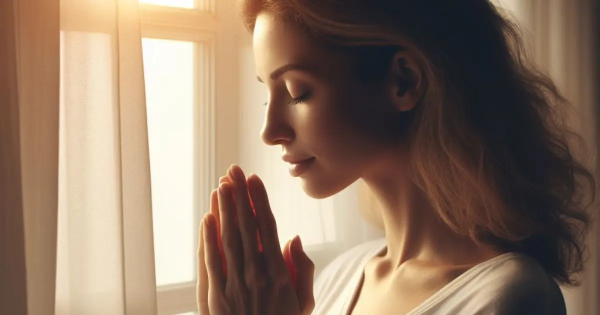 A 35-year-old woman stands by her window, bathed in soft morning light, hands clasped in prayer. She whispers, "God, give me strength to accept the things I cannot change.